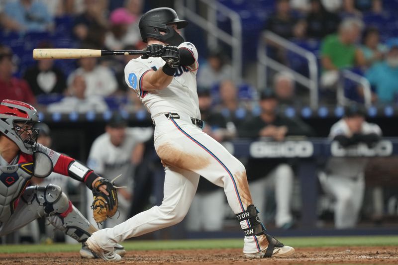 Aug 20, 2025; Miami, Florida, USA;  Miami Marlins left fielder Troy Johnston (75) drives in a run on a single in the fifth inning against the St. Louis Cardinals at loanDepot Park. Mandatory Credit: Jim Rassol-Imagn Images