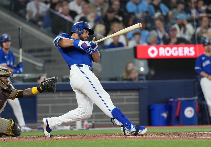 May 20, 2025; Toronto, Ontario, CAN; Toronto Blue Jays designated hitter Anthony Santander (25) hits a two-run home run against the San Diego Padres during the fifth inning at Rogers Centre. Mandatory Credit: Nick Turchiaro-Imagn Images
