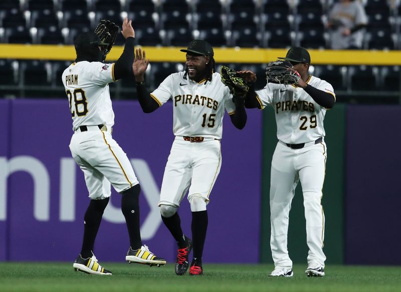 Apr 7, 2025; Pittsburgh, Pennsylvania, USA;  Pittsburgh Pirates left fielder Tommy Pham (28) and center fielder Oneil Cruz (15) and right fielder Alexander Canario (29) celebrate in the outfield after defeating the St. Louis Cardinals at PNC Park. Mandatory Credit: Charles LeClaire-Imagn Images
