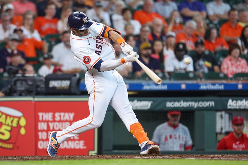 May 22, 2024; Houston, Texas, USA; Houston Astros shortstop Jeremy Pena (3) hits a double during the fourth inning against the Los Angeles Angels at Minute Maid Park. Mandatory Credit: Troy Taormina-USA TODAY Sports