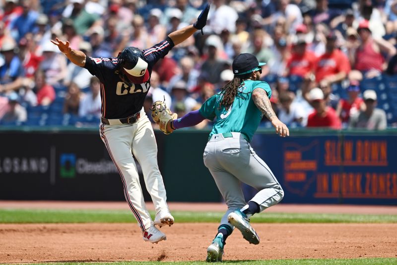 Jun 20, 2024; Cleveland, Ohio, USA; Cleveland Guardians second baseman Andres Gimenez (0) is tagged out by Seattle Mariners shortstop J.P. Crawford (3) during the first inning at Progressive Field. Mandatory Credit: Ken Blaze-USA TODAY Sports