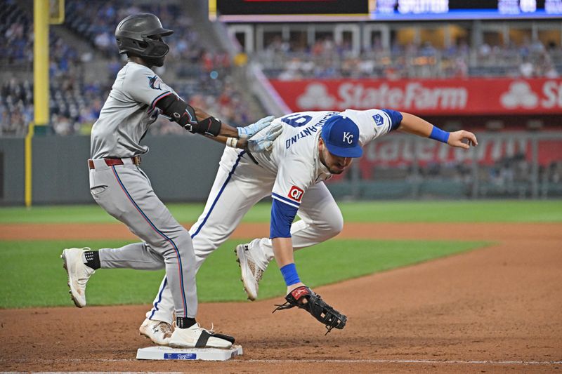 Jun 25, 2024; Kansas City, Missouri, USA; Miami Marlins left fielder Nick Gordon (1) is safe at first base after colliding with Kansas City Royals first baseman Vinnie Pasquantino (9) in the seventh inning at Kauffman Stadium. Mandatory Credit: Peter Aiken-USA TODAY Sports
