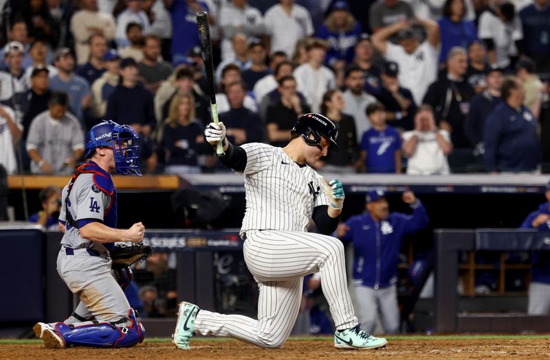 Oct 30, 2024; New York, New York, USA; New York Yankees first baseman Anthony Rizzo (48) strikes out in front of Los Angeles Dodgers catcher Will Smith (16) to end the eighth inning in game five of the 2024 MLB World Series at Yankee Stadium. Mandatory Credit: Vincent Carchietta-Imagn Images