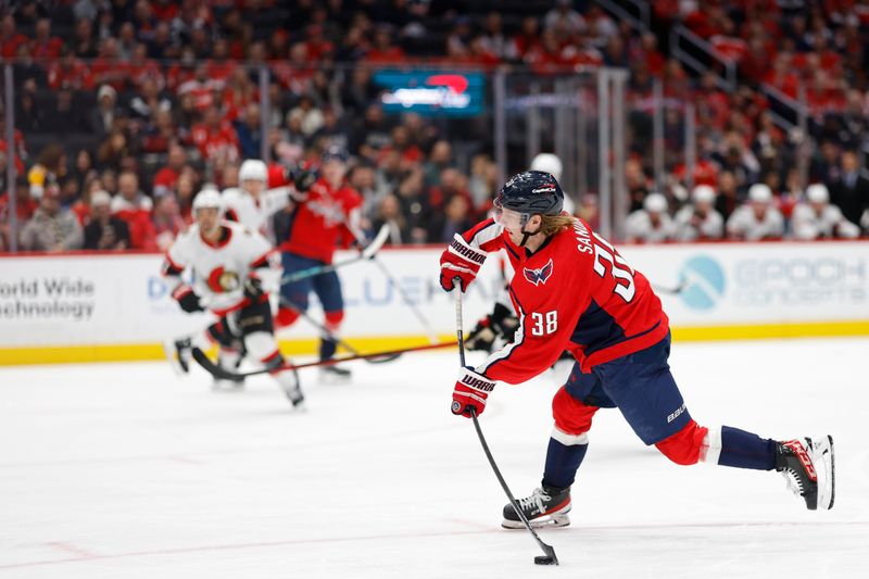 Feb 26, 2024; Washington, District of Columbia, USA; Washington Capitals defenseman Rasmus Sandin (38) shoots the puck against the Ottawa Senators in the third period at Capital One Arena. Mandatory Credit: Geoff Burke-USA TODAY Sports