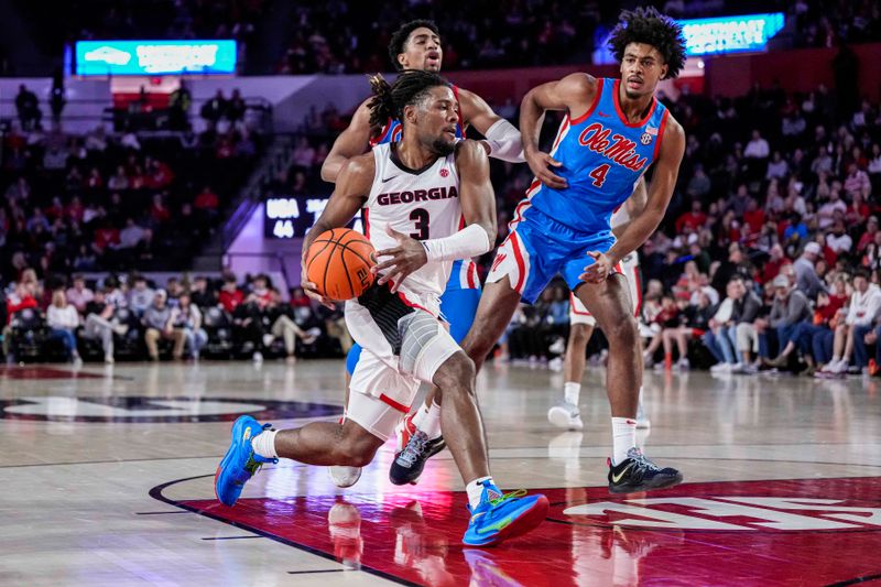 Feb 7, 2023; Athens, Georgia, USA; Georgia Bulldogs guard Kario Oquendo (3) runs past Mississippi Rebels forward Jaemyn Brakefield (4) during the second half at Stegeman Coliseum. Mandatory Credit: Dale Zanine-USA TODAY Sports