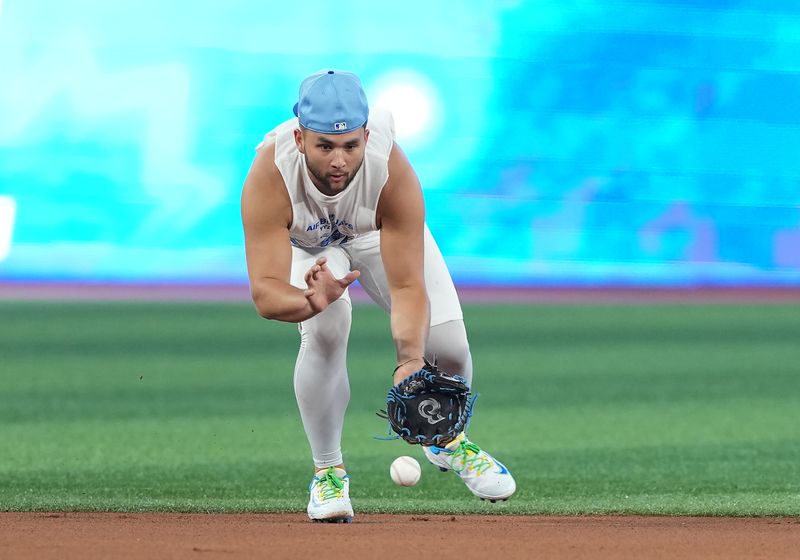 Jun 30, 2025; Toronto, Ontario, CAN; Toronto Blue Jays shortstop Bo Bichette (11) fields the ball during batting practice before a game against the New York Yankees at Rogers Centre. Mandatory Credit: Nick Turchiaro-Imagn Images