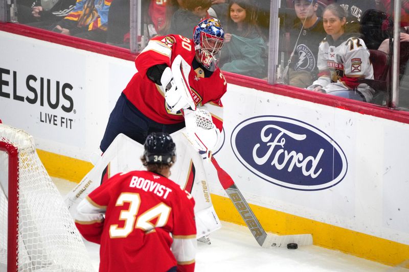 Sep 30, 2024; Sunrise, Florida, USA; Florida Panthers goaltender Spencer Knight (30) clears the puck against the Tampa Bay Lightning during the third period at Amerant Bank Arena. Mandatory Credit: Jim Rassol-Imagn Images