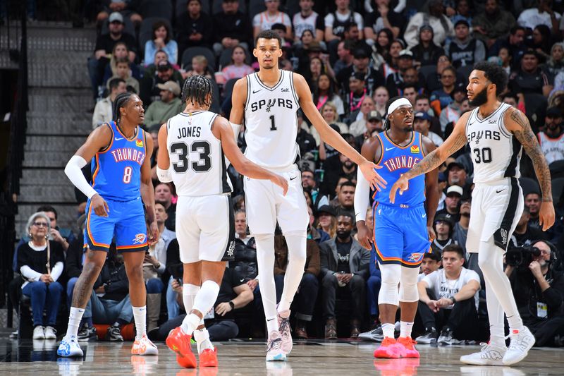 SAN ANTONIO, TX - FEBRUARY 29: Victor Wembanyama #1, Tre Jones #33 and Julian Champagnie #30 of the San Antonio Spurs high five during the game against the Oklahoma City Thunder on February 29, 2024 at the Frost Bank Center in San Antonio, Texas. NOTE TO USER: User expressly acknowledges and agrees that, by downloading and or using this photograph, user is consenting to the terms and conditions of the Getty Images License Agreement. Mandatory Copyright Notice: Copyright 2024 NBAE (Photos by Michael Gonzales/NBAE via Getty Images)