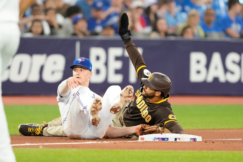 Jul 19, 2023; Toronto, Ontario, CAN; San Diego Padres center fielder Trent Grisham (1) steals third base on Toronto Blue Jays third baseman Matt Chapman (26) during the fifth inning at Rogers Centre. Mandatory Credit: John E. Sokolowski-USA TODAY Sports