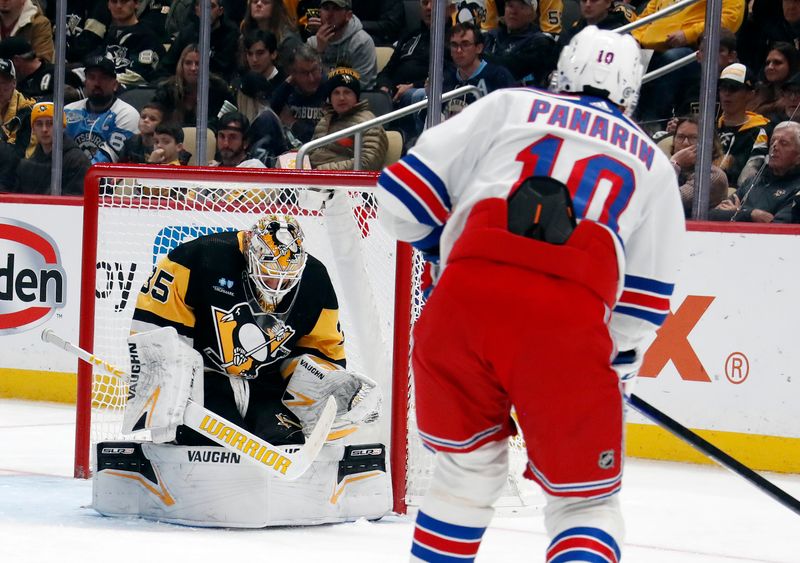 Nov 22, 2023; Pittsburgh, Pennsylvania, USA; Pittsburgh Penguins goaltender Tristan Jarry (35) makes a save against New York Rangers left wing Artemi Panarin (10) during the second period at PPG Paints Arena. Mandatory Credit: Charles LeClaire-USA TODAY Sports