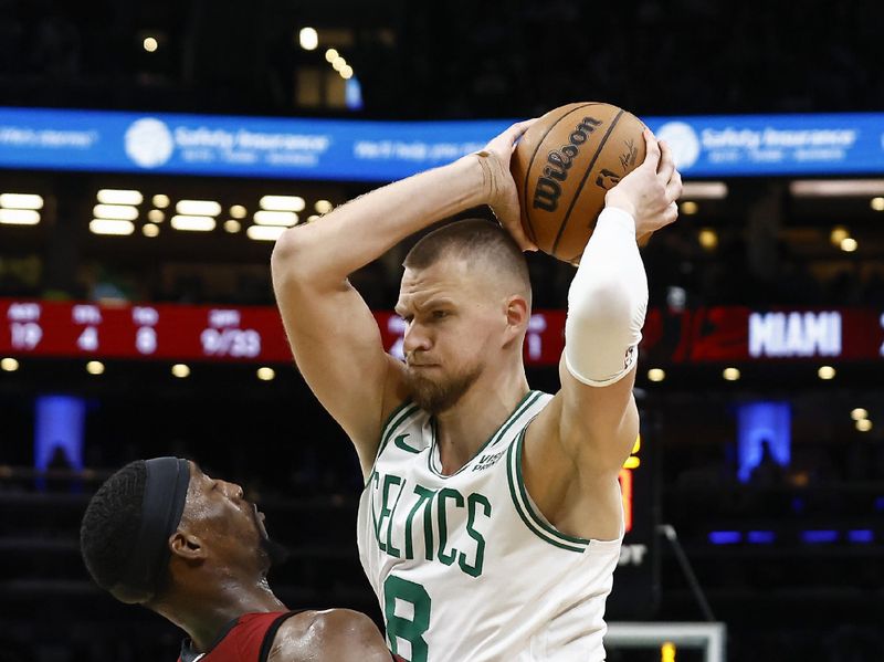 BOSTON, MA - APRIL 21: Kristaps Porzingis #8 of the Boston Celtics tries to get position on Bam Adebayo #13 of the Miami Heat during the second half of game one of the Eastern Conference First Round Playoffs at TD Garden on April 21, 2024 in Boston, Massachusetts. NOTE TO USER: User expressly acknowledges and agrees that, by downloading and/or using this Photograph, user is consenting to the terms and conditions of the Getty Images License Agreement. (Photo By Winslow Townson/Getty Images)