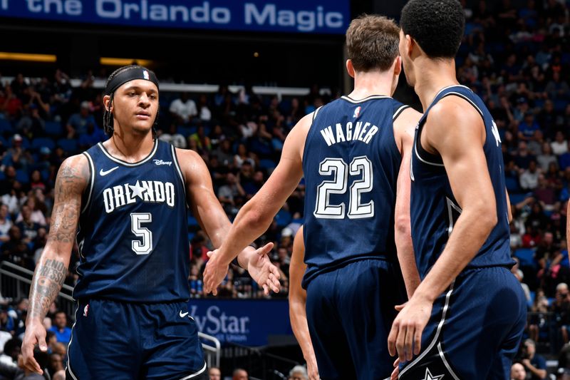 ORLANDO, FL - MARCH 21: Paolo Banchero #5 and Franz Wagner #22 of the Orlando Magic high five during the game against the New Orleans Pelicans on March 21, 2024 at Amway Center in Orlando, Florida. NOTE TO USER: User expressly acknowledges and agrees that, by downloading and or using this photograph, User is consenting to the terms and conditions of the Getty Images License Agreement. Mandatory Copyright Notice: Copyright 2024 NBAE (Photo by Fernando Medina/NBAE via Getty Images)