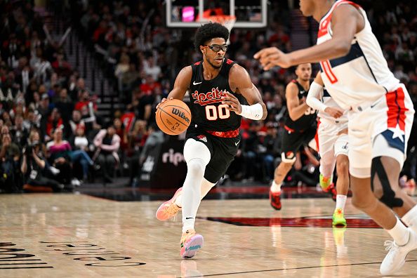 PORTLAND, OREGON - DECEMBER 21: Scoot Henderson #00 of the Portland Trail Blazers dribbles during the third quarter of the game against the Washington Wizards at the Moda Center on December 21, 2023 in Portland, Oregon. The Washington Wizards won 118-117. NOTE TO USER: User expressly acknowledges and agrees that, by downloading and or using this photograph, User is consenting to the terms and conditions of the Getty Images License Agreement. (Photo by Alika Jenner/Getty Images)