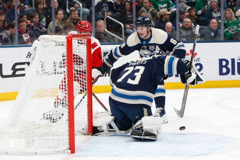 Mar 17, 2026; Columbus, Ohio, USA; Columbus Blue Jackets goalie Jet Greaves (73) makes a save on the shot attempt of Carolina Hurricanes defenseman Mike Reilly (6) during the third period at Nationwide Arena. Mandatory Credit: Russell LaBounty-Imagn Images