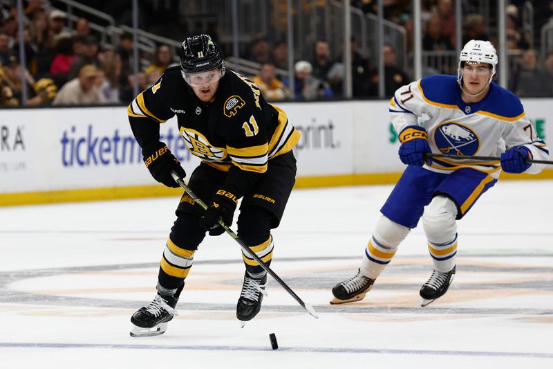Oct 11, 2025; Boston, Massachusetts, USA;  Boston Bruins center Casey Mittelstadt (11) carries the puck against the Buffalo Sabres during the first period at TD Garden. Mandatory Credit: Winslow Townson-Imagn Images