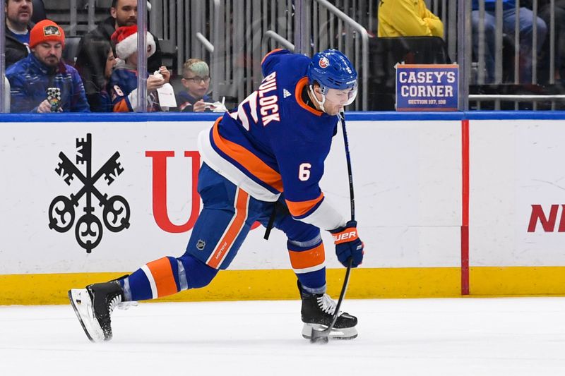 Dec 5, 2023; Elmont, New York, USA; New York Islanders defenseman Ryan Pulock (6) shoots and scores a goal against the San Jose Sharks  during the third period at UBS Arena. Mandatory Credit: Dennis Schneidler-USA TODAY Sports