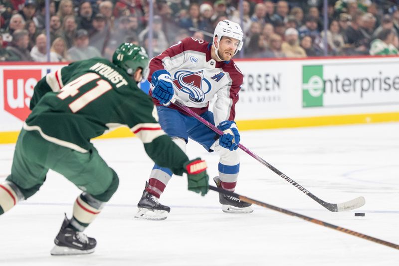 Mar 11, 2025; Saint Paul, Minnesota, USA; Colorado Avalanche defenseman Devon Toews (7) passes as Minnesota Wild center Gustav Nyquist (41) defends in the first period at Xcel Energy Center. Mandatory Credit: Matt Blewett-Imagn Images