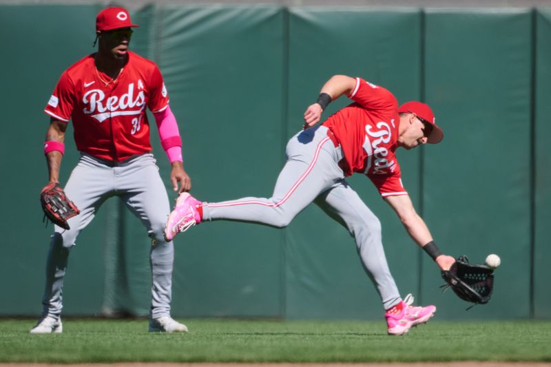 May 12, 2024; San Francisco, California, USA; Cincinnati Reds outfielders Spencer Steer (7) and outfielder TJ Friedl (29) cannot catch a fly ball hit by the San Francisco Giants during the ninth inning at Oracle Park. Mandatory Credit: Robert Edwards-USA TODAY Sports