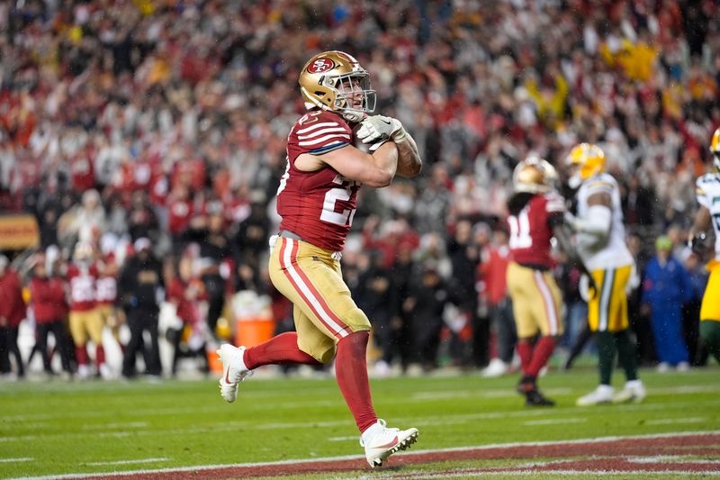 San Francisco 49ers running back Christian McCaffrey (23) scores a rushing touchdown during the second half of an NFL football NFC divisional playoff game against the Green Bay Packers Saturday, Jan. 20, 2024, in Santa Clara, Calif. (AP Photo/Ashley Landis)