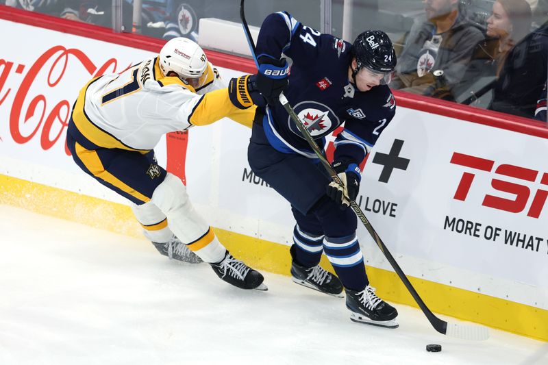 Oct 18, 2025; Winnipeg, Manitoba, CAN; Winnipeg Jets defenseman Haydn Fleury (24) is checked by Nashville Predators right wing Michael McCarron (47) in the third period at Canada Life Centre. Mandatory Credit: James Carey Lauder-Imagn Images