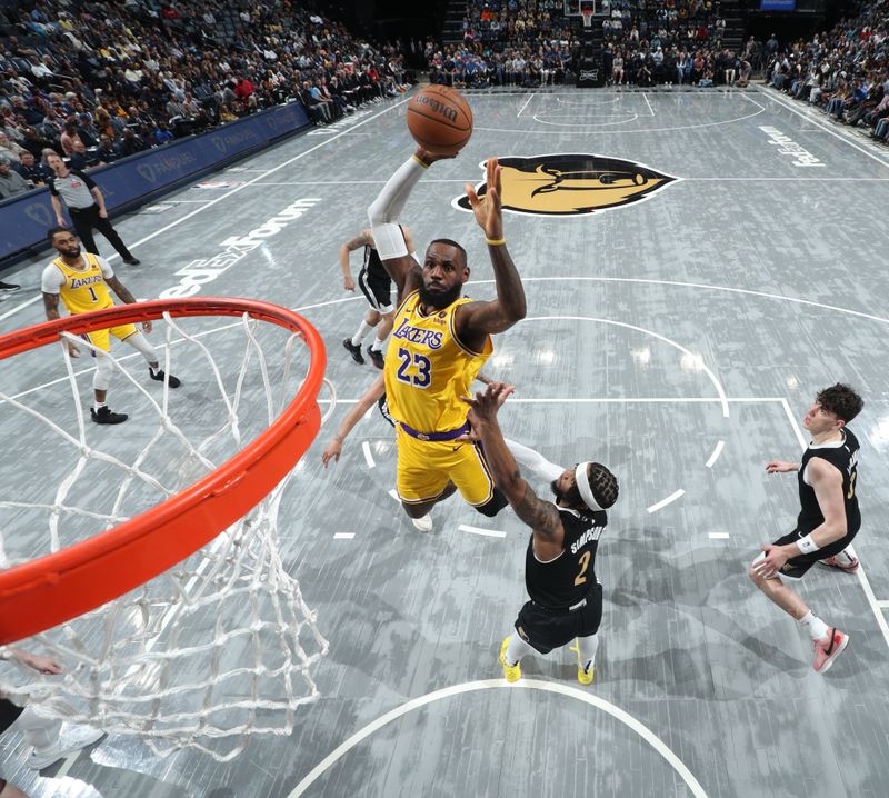 MEMPHIS, TN - APRIL 12:LeBron James #23 of the Los Angeles Lakers dunks the ball during the game against the Memphis Grizzlies  on April 12, 2024 at FedExForum in Memphis, Tennessee. NOTE TO USER: User expressly acknowledges and agrees that, by downloading and or using this photograph, User is consenting to the terms and conditions of the Getty Images License Agreement. Mandatory Copyright Notice: Copyright 2024 NBAE (Photo by Joe Murphy/NBAE via Getty Images)