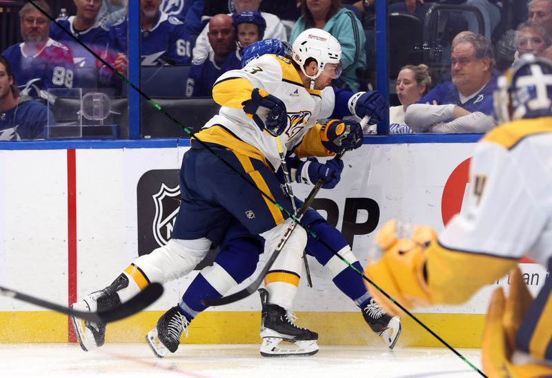 Oct 28, 2024; Tampa, Florida, USA; Nashville Predators defenseman Jeremy Lauzon (3) defends Tampa Bay Lightning center Luke Glendening (11) during the first period at Amalie Arena. Mandatory Credit: Kim Klement Neitzel-Imagn Images