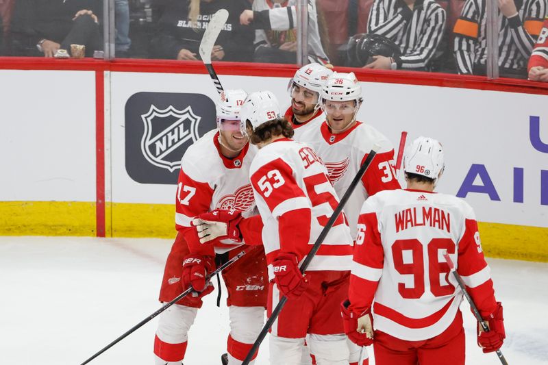 Feb 25, 2024; Chicago, Illinois, USA; Detroit Red Wings right wing Daniel Sprong (L) celebrates with teammates after scoring against the Chicago Blackhawks during the first period at United Center. Mandatory Credit: Kamil Krzaczynski-USA TODAY Sports