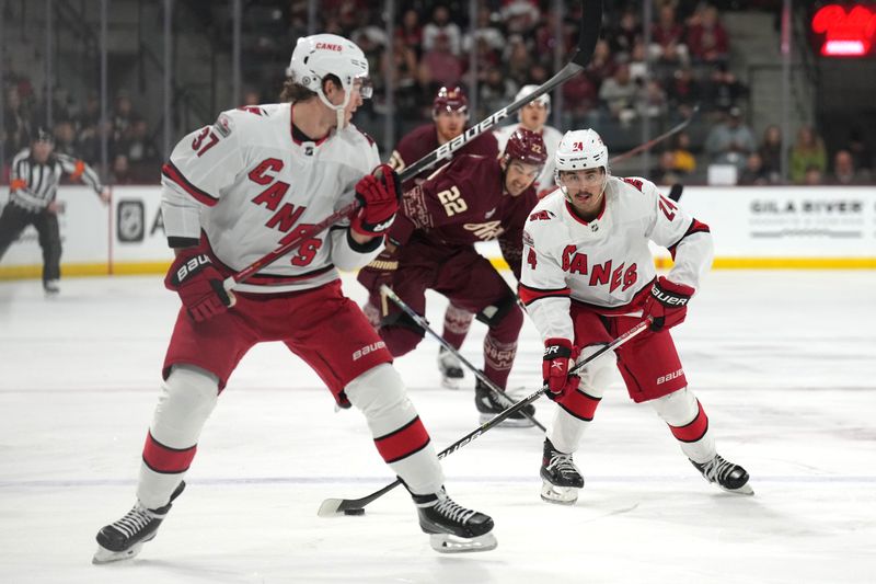 Mar 3, 2023; Tempe, Arizona, USA; Carolina Hurricanes center Seth Jarvis (24) skates the puck against the Arizona Coyotes during the first period at Mullett Arena. Mandatory Credit: Joe Camporeale-USA TODAY Sports