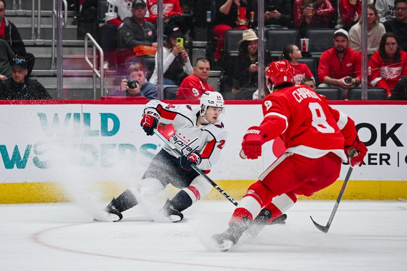 Feb 27, 2024; Detroit, Michigan, USA; Washington Capitals center Connor McMichael (24) brings the puck up ice against Detroit Red Wings defenseman Ben Chiarot (8) during the first period at Little Caesars Arena. Mandatory Credit: Tim Fuller-USA TODAY Sports