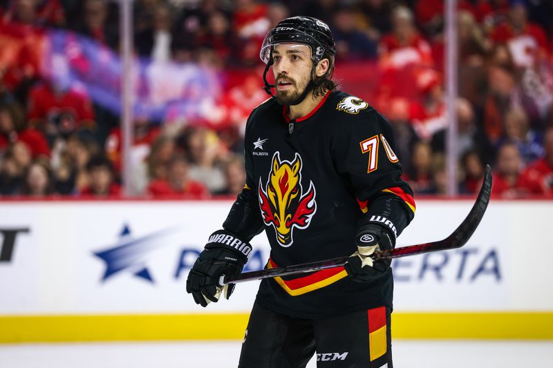 Dec 31, 2024; Calgary, Alberta, CAN; Calgary Flames left wing Ryan Lomberg (70) against the Vancouver Canucks during the second period at Scotiabank Saddledome. Mandatory Credit: Sergei Belski-Imagn Images