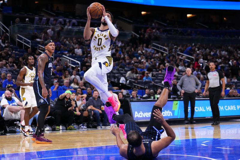 ORLANDO, FLORIDA - OCTOBER 28: Tyrese Haliburton #0 of the Indiana Pacers draws a offensive foul against Jalen Suggs #4 of the Orlando Magic during the third quarter at Kia Center on October 28, 2024 in Orlando, Florida. NOTE TO USER: User expressly acknowledges and agrees that, by downloading and or using this photograph, User is consenting to the terms and conditions of the Getty Images License Agreement. (Photo by Rich Storry/Getty Images)