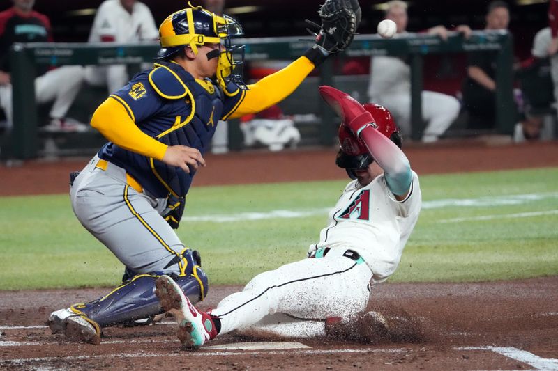 Sep 13, 2024; Phoenix, Arizona, USA; Arizona Diamondbacks outfielder Corbin Carroll (7) slides and beats a throw to Milwaukee Brewers catcher William Contreras (24) during the first inning at Chase Field. Mandatory Credit: Joe Camporeale-Imagn Images