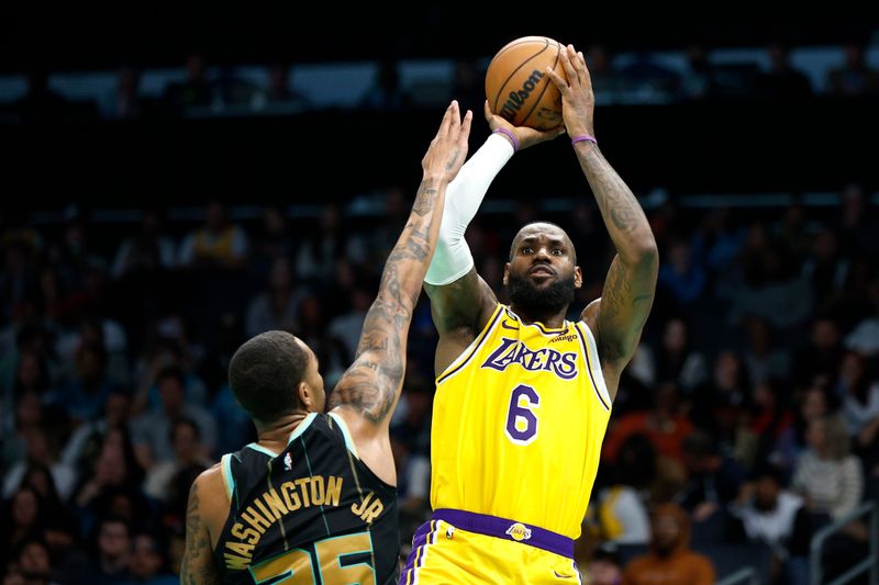 CHARLOTTE, NORTH CAROLINA - JANUARY 02: LeBron James #6 of the Los Angeles Lakers attempts a jump shot against P.J. Washington #25 of the Charlotte Hornets during the second half of the game at Spectrum Center on January 02, 2023 in Charlotte, North Carolina. NOTE TO USER: User expressly acknowledges and agrees that, by downloading and or using this photograph, User is consenting to the terms and conditions of the Getty Images License Agreement. (Photo by Jared C. Tilton/Getty Images)