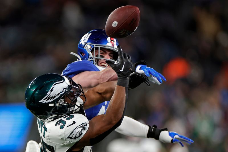 New York Giants linebacker Micah McFadden (41) breaks up a pass intended for Philadelphia Eagles running back Boston Scott (35) during an NFL football game Sunday, Jan. 7, 2024, in East Rutherford, N.J. (AP Photo/Adam Hunger)