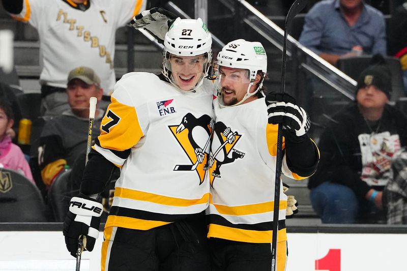 Jan 20, 2024; Las Vegas, Nevada, USA; Pittsburgh Penguins defenseman Ryan Graves (27) celebrates with Pittsburgh Penguins defenseman Erik Karlsson (65) after scoring a goal against the Vegas Golden Knights during the second period at T-Mobile Arena. Mandatory Credit: Stephen R. Sylvanie-USA TODAY Sports