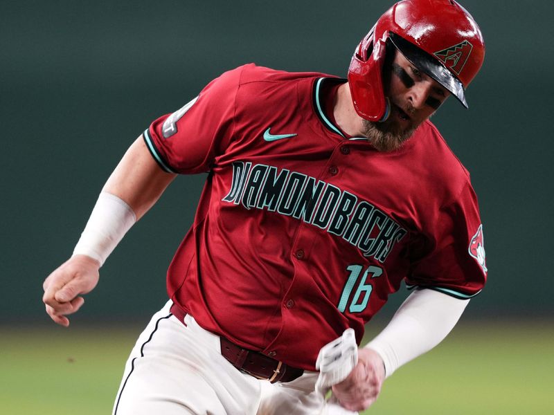 May 5, 2024; Phoenix, Arizona, USA; Arizona Diamondbacks catcher Tucker Barnhart (16) rounds third base and scores a run against the San Diego Padres during the fourth inning at Chase Field. Mandatory Credit: Joe Camporeale-USA TODAY Sports