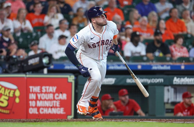 May 22, 2024; Houston, Texas, USA; Houston Astros catcher Victor Caratini (17) hits a double during the third inning against the Los Angeles Angels at Minute Maid Park. Mandatory Credit: Troy Taormina-USA TODAY Sports