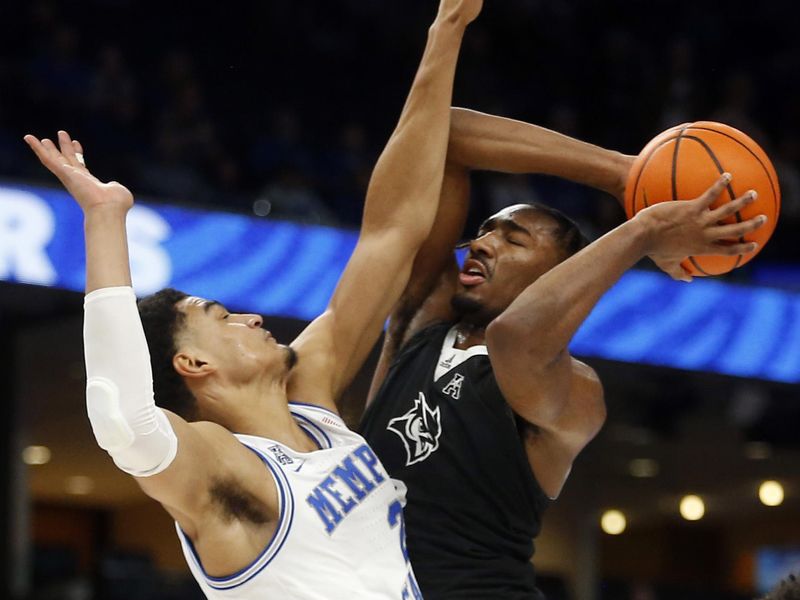 Jan 31, 2024; Memphis, Tennessee, USA; Rice Owls guard Mekhi Mason (2) drives to the basket as Memphis Tigers forward Nicholas Jourdain (2) defends during the second half at FedExForum. Mandatory Credit: Petre Thomas-USA TODAY Sports