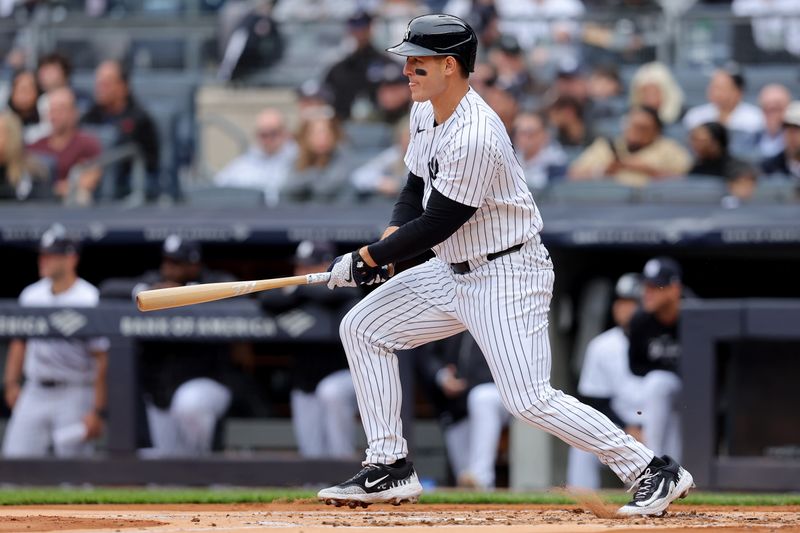 Apr 21, 2024; Bronx, New York, USA; New York Yankees first baseman Anthony Rizzo (48) follows through on an RBI single during the first inning against the Tampa Bay Rays at Yankee Stadium. Mandatory Credit: Brad Penner-USA TODAY Sports