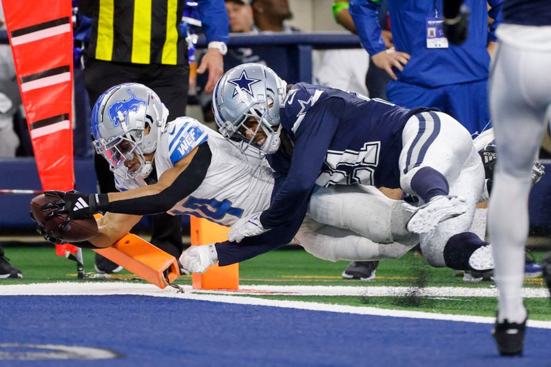 Detroit Lions wide receiver Amon-Ra St. Brown, left, scores a touchdown as Dallas Cowboys cornerback Stephon Gilmore tries to stop him during the second half of an NFL football game, Saturday, Dec. 30, 2023, in Arlington, Texas. The Cowboys won 20-19. (AP Photo/Michael Ainsworth)