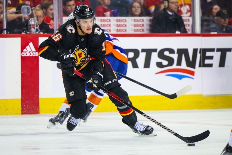 Nov 18, 2023; Calgary, Alberta, CAN; Calgary Flames defenseman Nikita Zadorov (16) controls the puck against the New York Islanders during the third period at Scotiabank Saddledome. Mandatory Credit: Sergei Belski-USA TODAY Sports