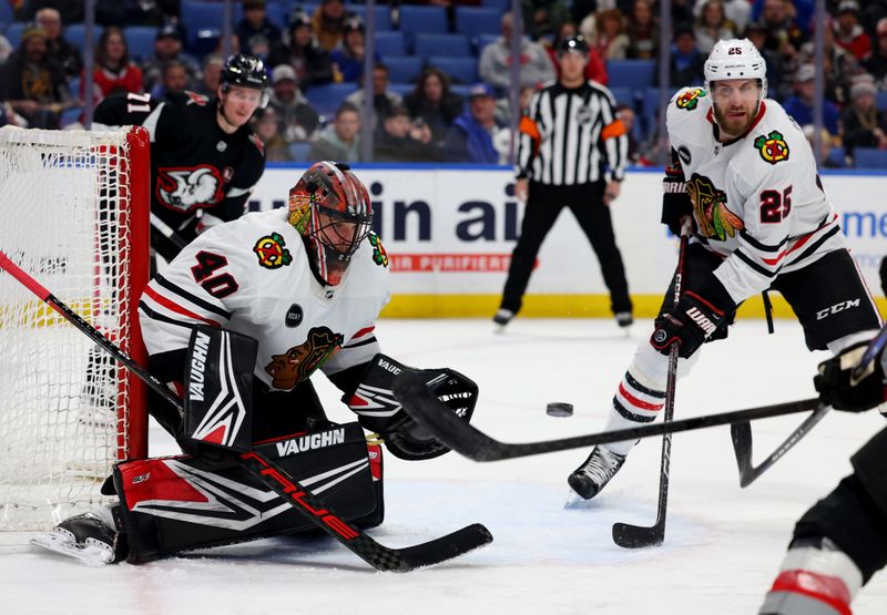 Jan 18, 2024; Buffalo, New York, USA;  Chicago Blackhawks defenseman Jarred Tinordi (25) watches as goaltender Arvid Soderblom (40) looks to make a save during the second period against the Buffalo Sabres at KeyBank Center. Mandatory Credit: Timothy T. Ludwig-USA TODAY Sports