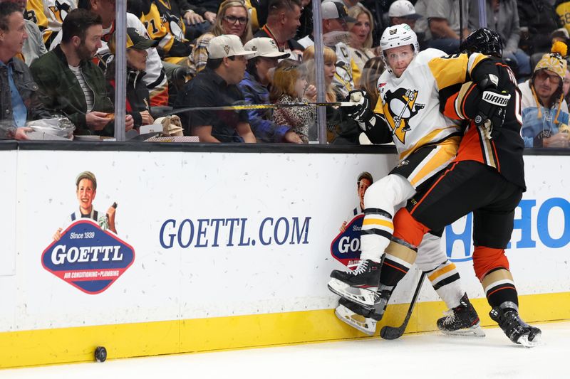 Nov 7, 2023; Anaheim, California, USA; Pittsburgh Penguins left wing Jake Guentzel (59) is checked by Anaheim Ducks defenseman Cam Fowler (4) during the first period at Honda Center. Mandatory Credit: Kiyoshi Mio-USA TODAY Sports