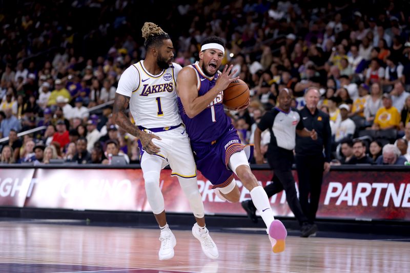 PALM SPRINGS, CALIFORNIA - OCTOBER 06: Devin Booker #1 of the Phoenix Suns drives against D'Angelo Russell #1 of the Los Angeles Lakers during the first quarter at Acrisure Arena on October 06, 2024 in Palm Springs, California. NOTE TO USER: User expressly acknowledges and agrees that, by downloading and/or using this photograph, user is consenting to the terms and conditions of the Getty Images License Agreement. (Photo by Katelyn Mulcahy/Getty Images)