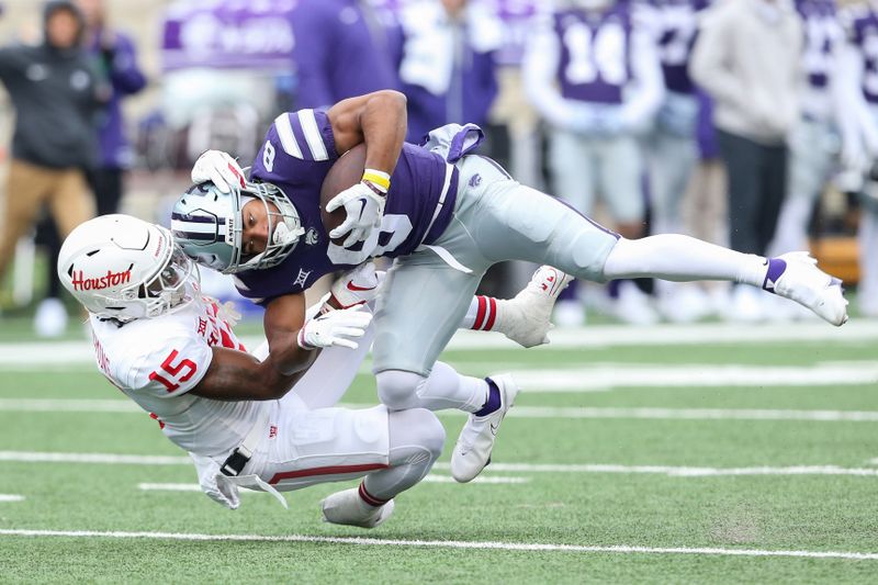 Oct 28, 2023; Manhattan, Kansas, USA; Kansas State Wildcats wide receiver Phillip Brooks (8) is tackled by Houston Cougars defensive back Malik Fleming (15)] during the second quarter at Bill Snyder Family Football Stadium. Mandatory Credit: Scott Sewell-USA TODAY Sports