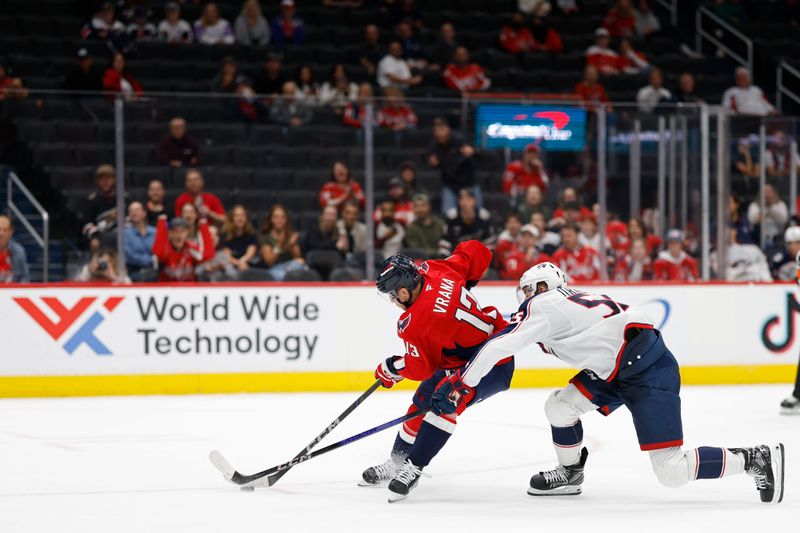 Sep 27, 2024; Washington, District of Columbia, USA; Washington Capitals forward Jakob Vrana (13) skates with the puck as Columbus Blue Jackets defenseman David Jiricek (55) defends in the third period at Capital One Arena. Mandatory Credit: Geoff Burke-Imagn Images