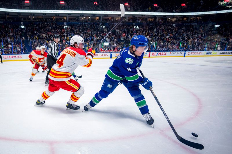 Apr 16, 2024; Vancouver, British Columbia, CAN; Calgary Flames defenseman Rasmus Andersson (4) battles with Vancouver Canucks forward Brock Boeser (6) in the third period at Rogers Arena. Canucks won 4 -1. Mandatory Credit: Bob Frid-USA TODAY Sports