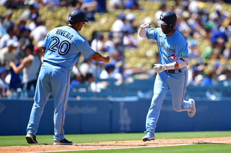 Jul 26, 2023; Los Angeles, California, USA; Toronto Blue Jays left fielder Whit Merrifield (15) is greeted by third base coach Luis Rivera (20) after hitting a three run home run against the Los Angeles Dodgers during the fifth inning at Dodger Stadium. Mandatory Credit: Gary A. Vasquez-USA TODAY Sports