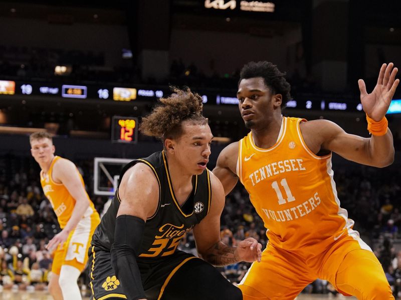 Feb 20, 2024; Columbia, Missouri, USA; Missouri Tigers forward Noah Carter (35) dribbles the ball as Tennessee Volunteers forward Tobe Awaka (11) defends during the first half at Mizzou Arena. Mandatory Credit: Denny Medley-USA TODAY Sports