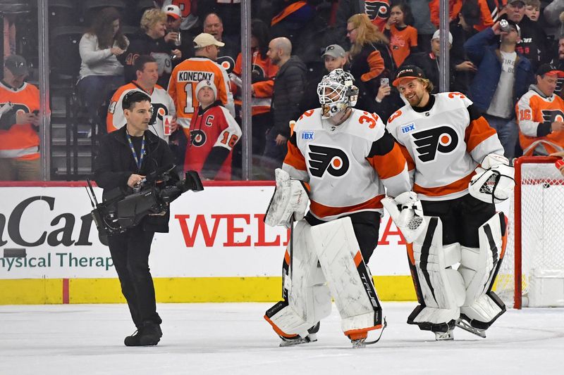 Mar 2, 2024; Philadelphia, Pennsylvania, USA; Philadelphia Flyers goaltender Felix Sandstrom (32) and goaltender Samuel Ersson (33) celebrate win against the Ottawa Senators at Wells Fargo Center. Mandatory Credit: Eric Hartline-USA TODAY Sports